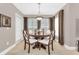 Dining area with a round table and four white chairs at 5460 E Michigan St # 7, Orlando, FL 32812