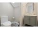 Powder room with pedestal sink and toilet at 7768 Linkside Loop, Reunion, FL 34747