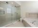 Modern bathroom with a large walk-in shower and soaking tub at 7768 Linkside Loop, Reunion, FL 34747