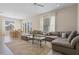 Bright living room with large sectional sofa and dining area at 7768 Linkside Loop, Reunion, FL 34747