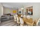 Open concept dining room with glass-top table and seating for eight at 7768 Linkside Loop, Reunion, FL 34747
