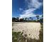 Sand volleyball court with nets and posts, set against a backdrop of palm trees and resort buildings at 370 Lasso Dr, Kissimmee, FL 34747