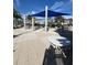 Pool deck with tables and chairs under a blue shade sail at 370 Lasso Dr, Kissimmee, FL 34747