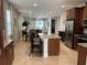 Kitchen with granite island, stainless steel appliances, and dark cabinets at 370 Lasso Dr, Kissimmee, FL 34747