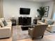Bright living room featuring two sofas, a coffee table, and a large TV at 370 Lasso Dr, Kissimmee, FL 34747