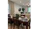 Dining room with a dark wood table, six chairs, and a view of the living room at 370 Lasso Dr, Kissimmee, FL 34747