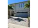 Modern home exterior with gray garage door at 370 Lasso Dr, Kissimmee, FL 34747