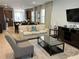 Open living room, kitchen, and dining area with beige sofas and a large TV at 370 Lasso Dr, Kissimmee, FL 34747