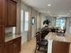 Open concept kitchen with island seating and view into living room at 370 Lasso Dr, Kissimmee, FL 34747