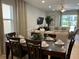 Dining room with a dark wood table, six chairs, and a view of the living room at 370 Lasso Dr, Kissimmee, FL 34747