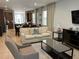 Open living room, kitchen, and dining area with beige sofas and a large TV at 370 Lasso Dr, Kissimmee, FL 34747