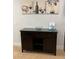 Dark wood cabinet with wine theme artwork in the entryway at 370 Lasso Dr, Kissimmee, FL 34747