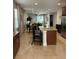 Kitchen with granite island, stainless steel appliances, and dark cabinets at 370 Lasso Dr, Kissimmee, FL 34747