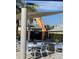 Pool deck with tables and chairs under a shade sail at 370 Lasso Dr, Kissimmee, FL 34747