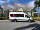 White Encore Resort shuttle parked in front of resort building at 370 Lasso Dr, Kissimmee, FL 34747