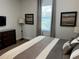 Spacious bedroom with large bed, dresser, and window coverings at 370 Lasso Dr, Kissimmee, FL 34747