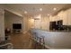 Open concept kitchen with breakfast bar and gray countertops at 1165 Trappers Trail Loop, Davenport, FL 33896