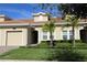 Tan two-story townhome with a two-car garage at 1165 Trappers Trail Loop, Davenport, FL 33896