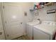 Laundry room with washer, dryer, and shelving at 1165 Trappers Trail Loop, Davenport, FL 33896