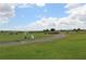 Scenic driving range with a putting green and golf carts at 1165 Trappers Trail Loop, Davenport, FL 33896