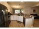 Modern kitchen with white cabinets, gray countertops, and stainless steel appliances at 1165 Trappers Trail Loop, Davenport, FL 33896