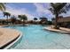 Resort-style pool with palm trees and a thatched-roof cabana at 1165 Trappers Trail Loop, Davenport, FL 33896
