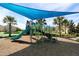 playground with a shaded area and play equipment at 1165 Trappers Trail Loop, Davenport, FL 33896
