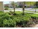 Landscaped front yard with lush greenery and palm trees at 1165 Trappers Trail Loop, Davenport, FL 33896