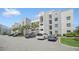 Modern building exterior with ample parking at 4721 Clock Tower Dr # 304, Kissimmee, FL 34746