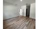 Spacious bedroom with wood-look flooring and access to hallway at 14759 Sw 43Rd Terrace Rd, Ocala, FL 34473