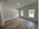 Bright bedroom with wood-look floors and two windows at 14759 Sw 43Rd Terrace Rd, Ocala, FL 34473