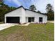 Modern home exterior with a black and white color scheme and landscaped yard at 14759 Sw 43Rd Terrace Rd, Ocala, FL 34473