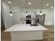 Modern kitchen with island, stainless steel appliances, and white cabinets at 14759 Sw 43Rd Terrace Rd, Ocala, FL 34473