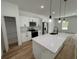 Modern kitchen with white cabinets, island, and pantry at 14759 Sw 43Rd Terrace Rd, Ocala, FL 34473