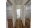 Hallway with three closets and wood-look floors at 14759 Sw 43Rd Terrace Rd, Ocala, FL 34473