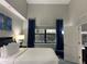 Bright bedroom with a queen-size bed and blue curtains at 14501 Grove Resort Ave # 1105, Winter Garden, FL 34787