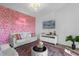 Living room with a sofa and unique floral wall at 3191 Paradox Cir # 202, Kissimmee, FL 34746