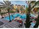 Large resort pool with surrounding lounge chairs and building at 12521 Floridays Resort Dr # 511F, Orlando, FL 32821