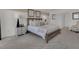 Main bedroom with king-size bed, nightstands, and access to a sitting area at 3438 Sabatia Ln, Poinciana, FL 34759