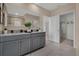 Double vanity bathroom with granite countertops and walk-in closet access at 3438 Sabatia Ln, Poinciana, FL 34759