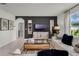 Cozy living room features a sectional sofa and a view into the bathroom at 3438 Sabatia Ln, Poinciana, FL 34759