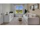 Bright office with window seat, built-in shelving, and a view of a lush landscape at 3438 Sabatia Ln, Poinciana, FL 34759