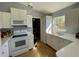 Kitchen with white cabinets and appliances at 825 Charles Ave, Orange City, FL 32763
