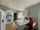 Bright kitchen with white cabinets, and speckled countertops at 825 Charles Ave, Orange City, FL 32763
