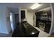 Modern condo kitchen, dark cabinetry, granite counters at 5479 Vineland Rd # 9201, Orlando, FL 32811