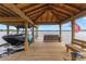 Covered boat dock with seating area and lake view at 208 Green Lake Cir, Longwood, FL 32779