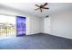 Bedroom with balcony access, ceiling fan and gray carpet at 2920 Pecan Ave, Leesburg, FL 34748
