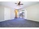 Bedroom with a ceiling fan, gray carpet, and access to a balcony at 2920 Pecan Ave, Leesburg, FL 34748