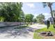 Residential community entrance with a paved road and lush greenery at 2920 Pecan Ave, Leesburg, FL 34748