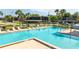 L-shaped community pool with plenty of lounge chairs at 2920 Pecan Ave, Leesburg, FL 34748